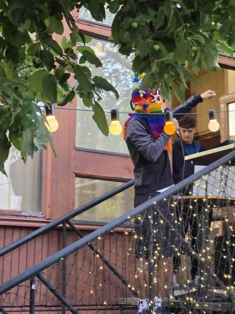 Flakkan i mask uppträder på trappsatsen intill DJ-bordet på Årstabo under Boom Bap Spots event.